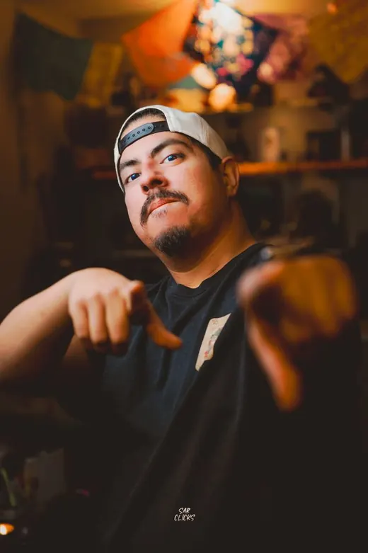 Portrait of Chris Longoria pointing at the camera